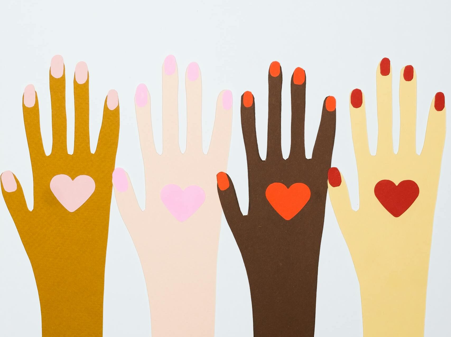 Four colorful hands with heart symbols representing diversity and inclusion.